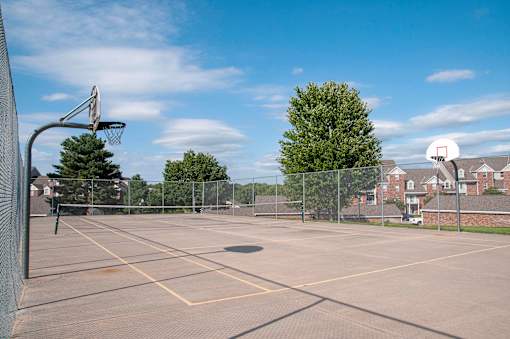 Outdoor Fenced Basketball Court with Two Hoops