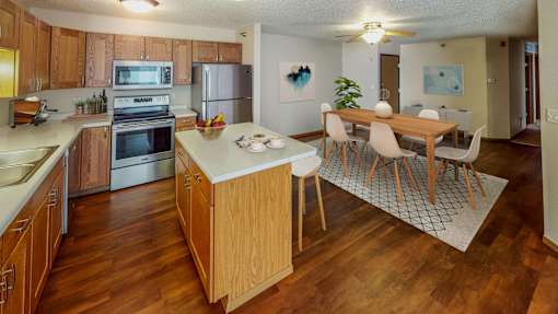 Bright and spacious kitchen with stainless steel appliances, large island, and separate dining area.
