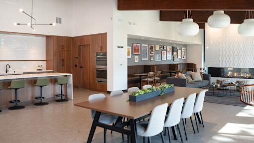 a dining room and living room with a table and chairs at The Bosk Apartment Homes, Woodbury, Minnesota