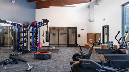 a gym with cardio machines and other exercise equipment at The Bosk Apartment Homes, Woodbury, MN