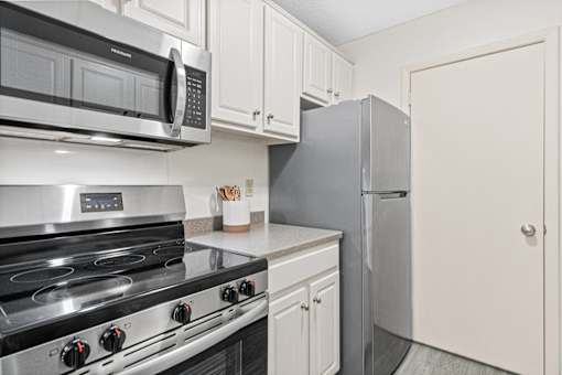 Kitchen with appliances at The Bosk Apartment Homes, Woodbury