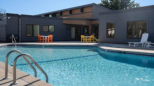 a swimming pool with a house in the background at The Bosk Apartment Homes, Minnesota