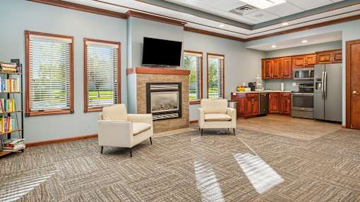 A living room with a fireplace and a television.