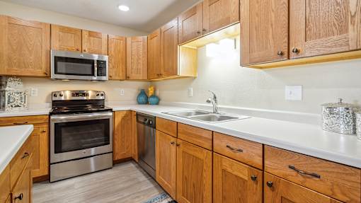 A kitchen with wooden cabinets and stainless steel appliances.