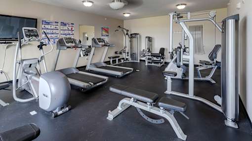 a room filled with lots of different types of exercise equipment