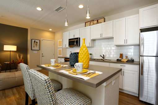 Modern kitchen with ample storage in the white cabinetry. The kitchen island is spacious and perfect for entertaining guests.