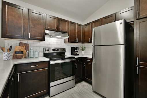 Kitchen with Wood Cabinets and Stainless Steel Fridge
