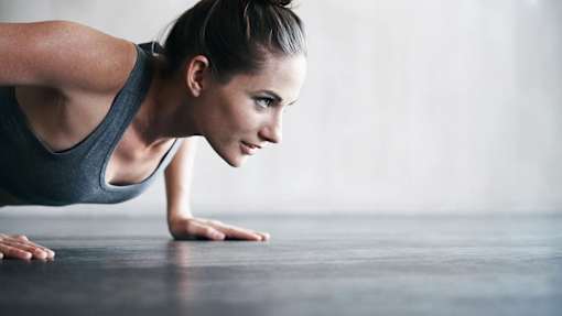 a woman is doing a plank on the floor