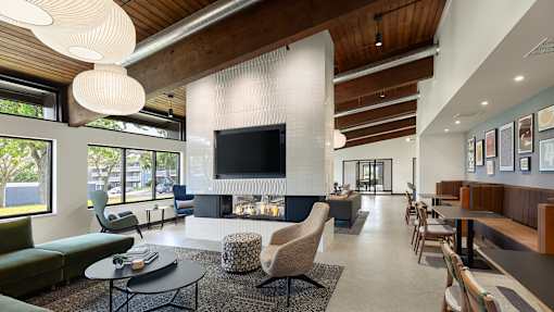A modern living room with a fireplace and a television at The Bosk Apartment Homes, Woodbury, 55125