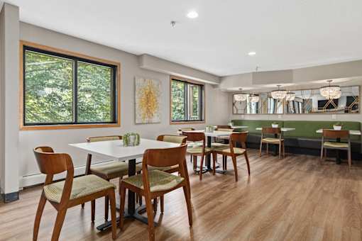 A dining room with a long table and chairs.
