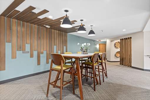 A dining room with a wooden table and chairs.