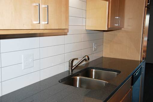 Kitchen with tile backsplash and granite countertops