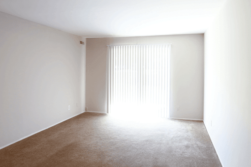 a bedroom with white walls and white carpet