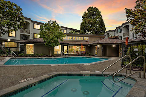 a swimming pool with a building in the background
