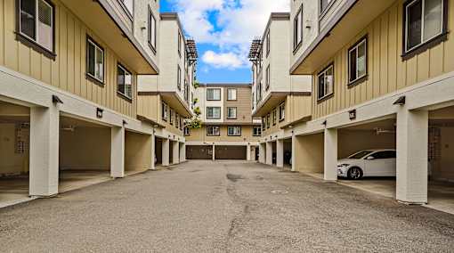 an empty parking lot in a large apartment building