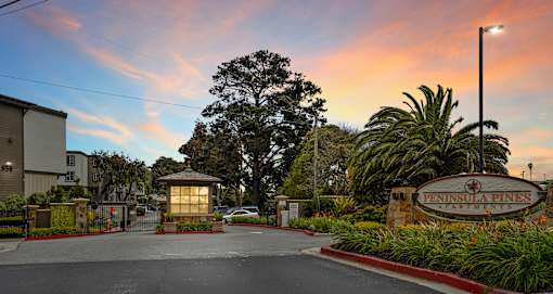 a city entrance with a sign that says Peninsula Pines Apartments