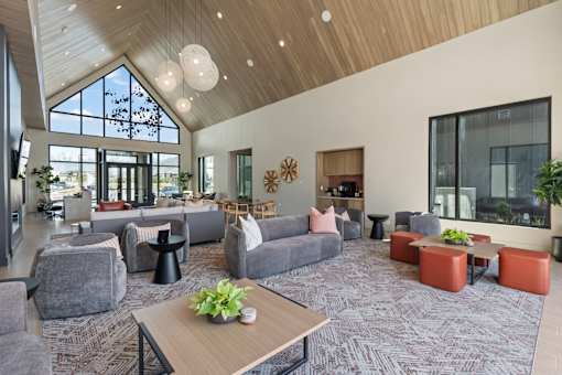 A large open space with a variety of seating options and a long table in the center.