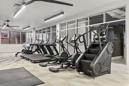 A gym with treadmills and elliptical machines.