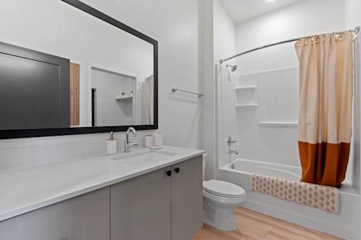A bathroom with a white sink and a white toilet.