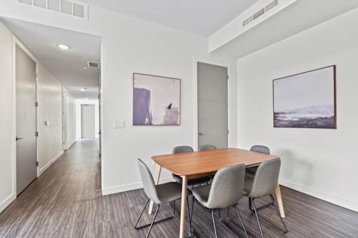 A conference room with a long table and chairs.