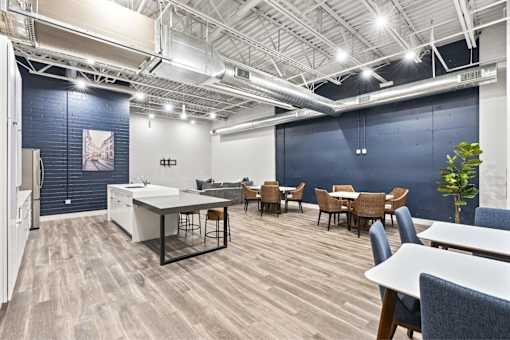 A modern office space with a white desk and chairs.