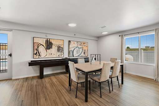 a dining room with a table and chairs and a window at Red Rock Apartments, Rapid City, SD