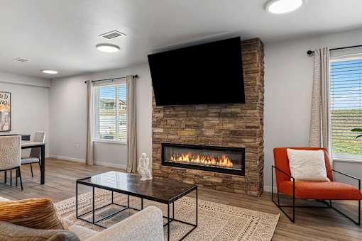 a living room with a fireplace and a television at Red Rock Apartments, Rapid City, SD, 57702