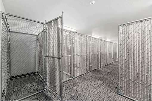 a row of metal cages in a white room at Red Rock Apartments, Rapid City, South Dakota