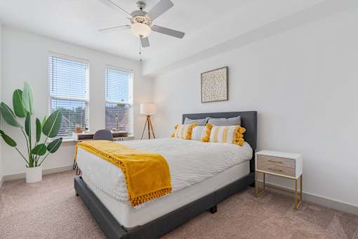 a bedroom with a bed and a ceiling fan at City View St. George Apartments, Utah