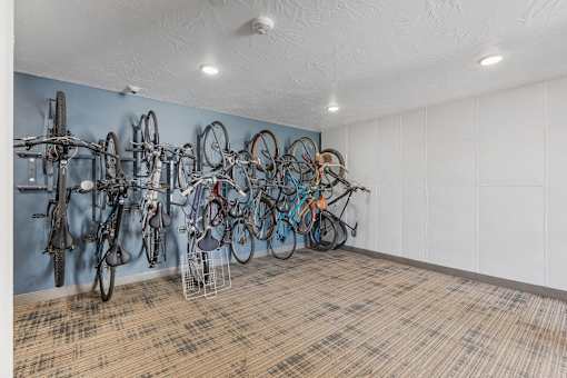 a room with many bikes hanging on the wall at City View St. George Apartments, St George, UT, 84770