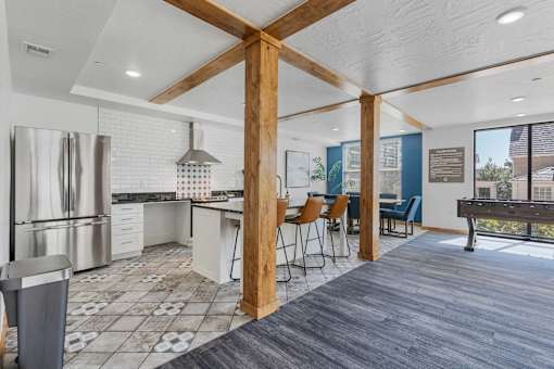 an open kitchen and dining area with a bar and a pool table at City View St. George Apartments, St George