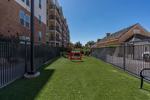 the yard is fenced in with a table and chairs on the grass at City View St. George Apartments, St George, Utah