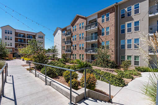 steps leading up to an apartment building with stairs and landscaping at City View St. George Apartments, Utah
