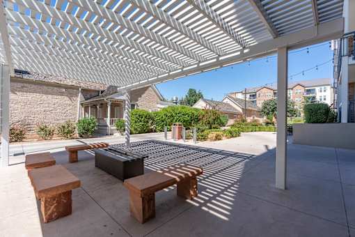 a covered patio with benches and a fire pit at City View St. George Apartments, Utah, 84770