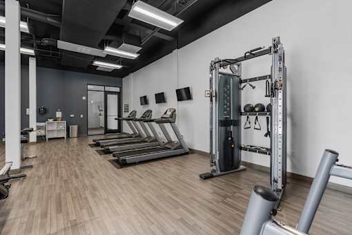 a fitness room with treadmills and weights in it at City View St. George Apartments, Utah