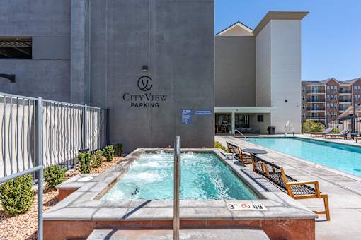 a swimming pool in front of a cityview parking building at City View St. George Apartments, St George, Utah