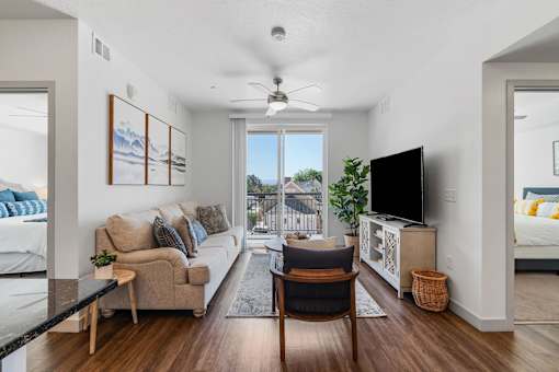 a living room with a couch and a chair and a tv at City View St. George Apartments, St George, UT, 84770