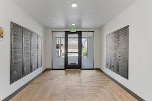a hallway with lockers and a door to a building at City View St. George Apartments, St George, Utah