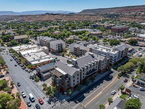 an aerial view of a city with buildings and cars on the street at City View St. George Apartments, St George