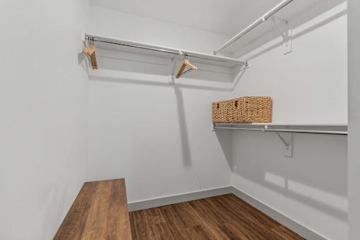 a walk in closet with white walls and a wood floor at City View St. George Apartments, St George, UT, 84770