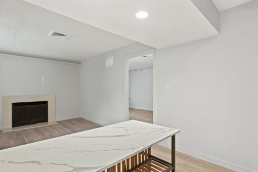 a living room with a marble table and a fireplace at AVIA Lofts on Liberty Ridge, Jacksonville, FL, 32256