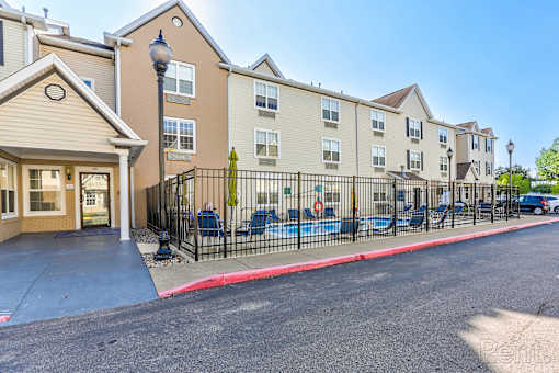 A sunny day at a residential building with a playground in front.