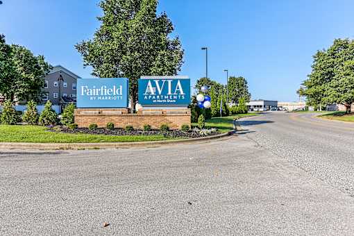 A road with a sign for Fairfield by Marriott and Aviva Apartments.