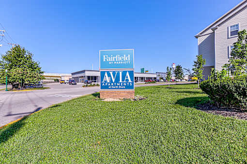 A sign for Fairfield Apartments is displayed in front of a building.