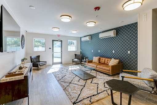 A living room with a sofa, chairs, and a coffee table.