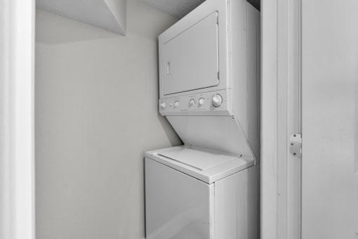 an empty laundry room with a washer and dryer