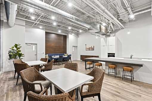 A conference room with a long table surrounded by chairs.