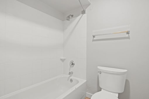a white bathroom with a tub and a toilet at AVIA Lofts on Liberty Ridge, Florida