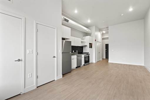 A kitchen with white appliances and cabinets is shown.