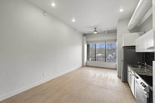 A kitchen with a dining area and a window.